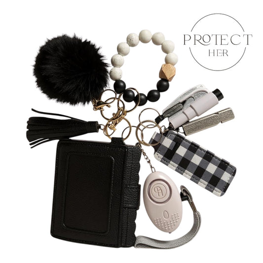 Black keychain pouch with various accessories including a pom-pom, beaded bracelet, and self-defense device Protect Her