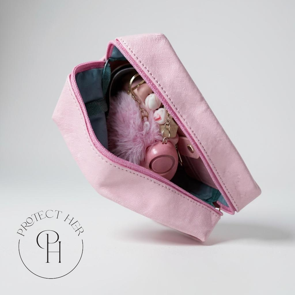 Pink pouch with keys and a fluffy item featuring 'Protect Her' logo.